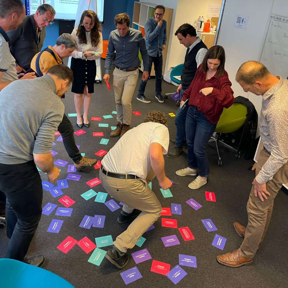 Participants picking core value cards on the floor.